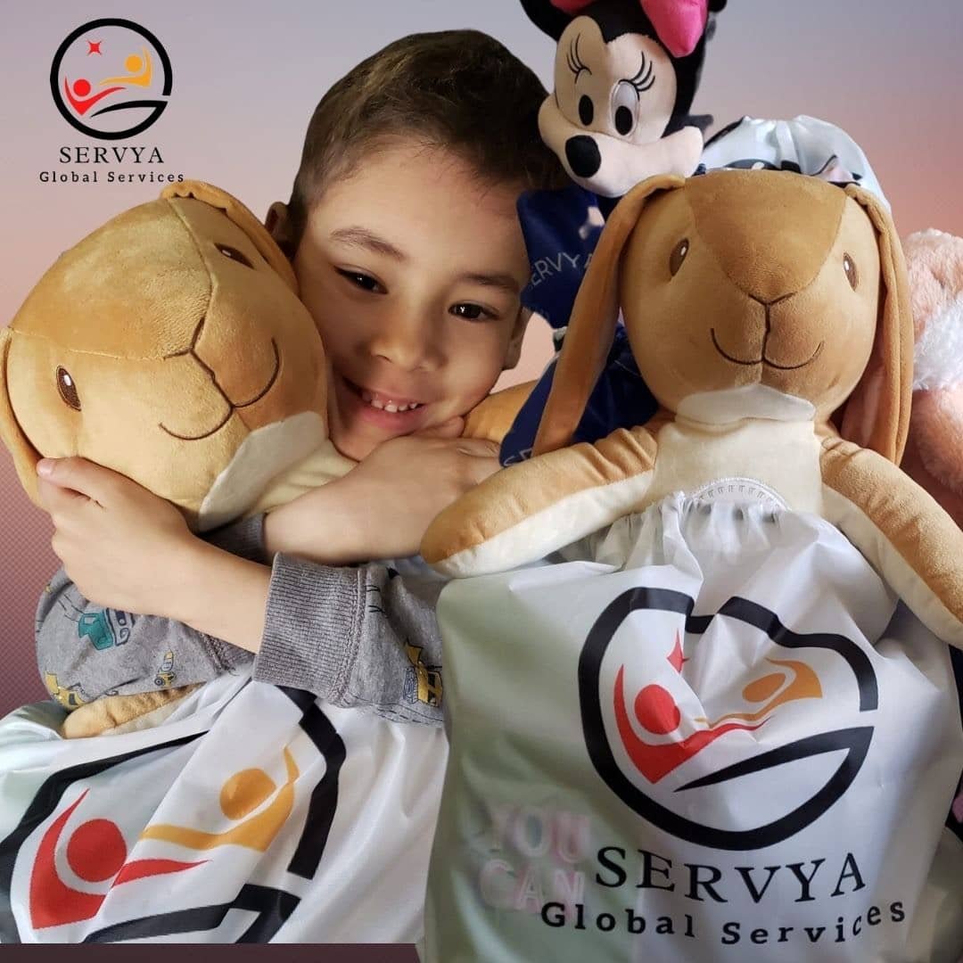 Child with comfort bags showing our work